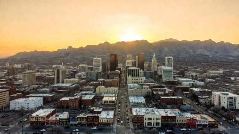 Utah small business marketing — Salt Lake City skyline with Wasatch Mountains and thriving local businesses