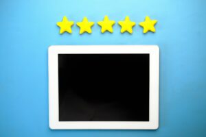 Customer leaving a five star review for a local business on a smartphone
