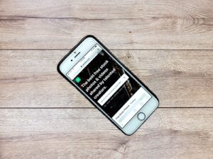 Business owner reviewing a landing page on a smartphone for common landing page mistakes