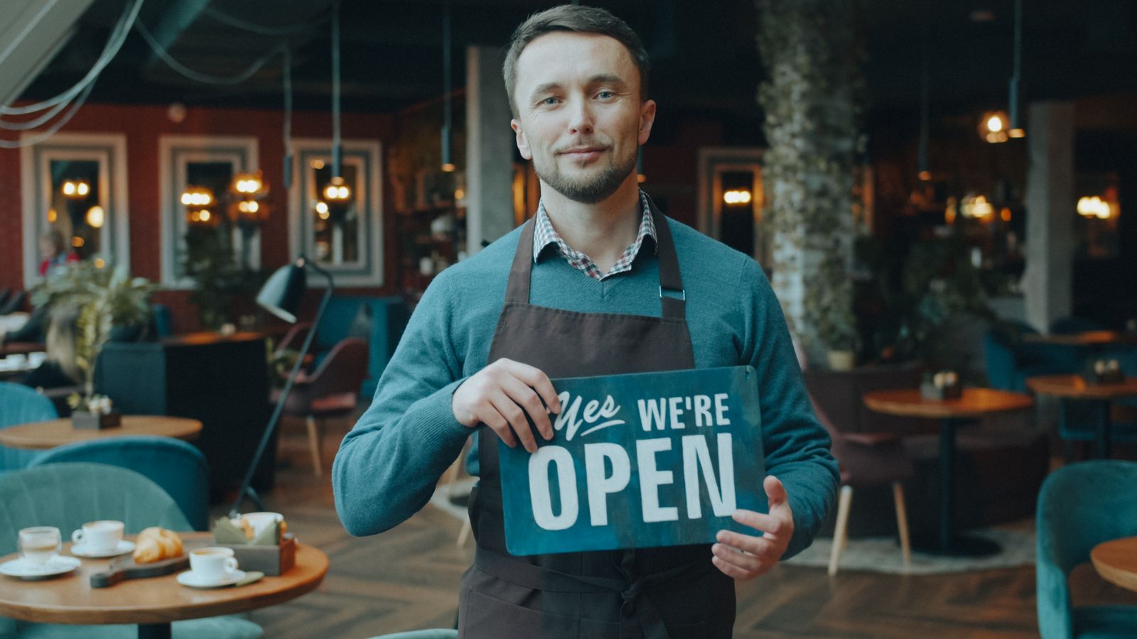 Small business owner welcoming customers